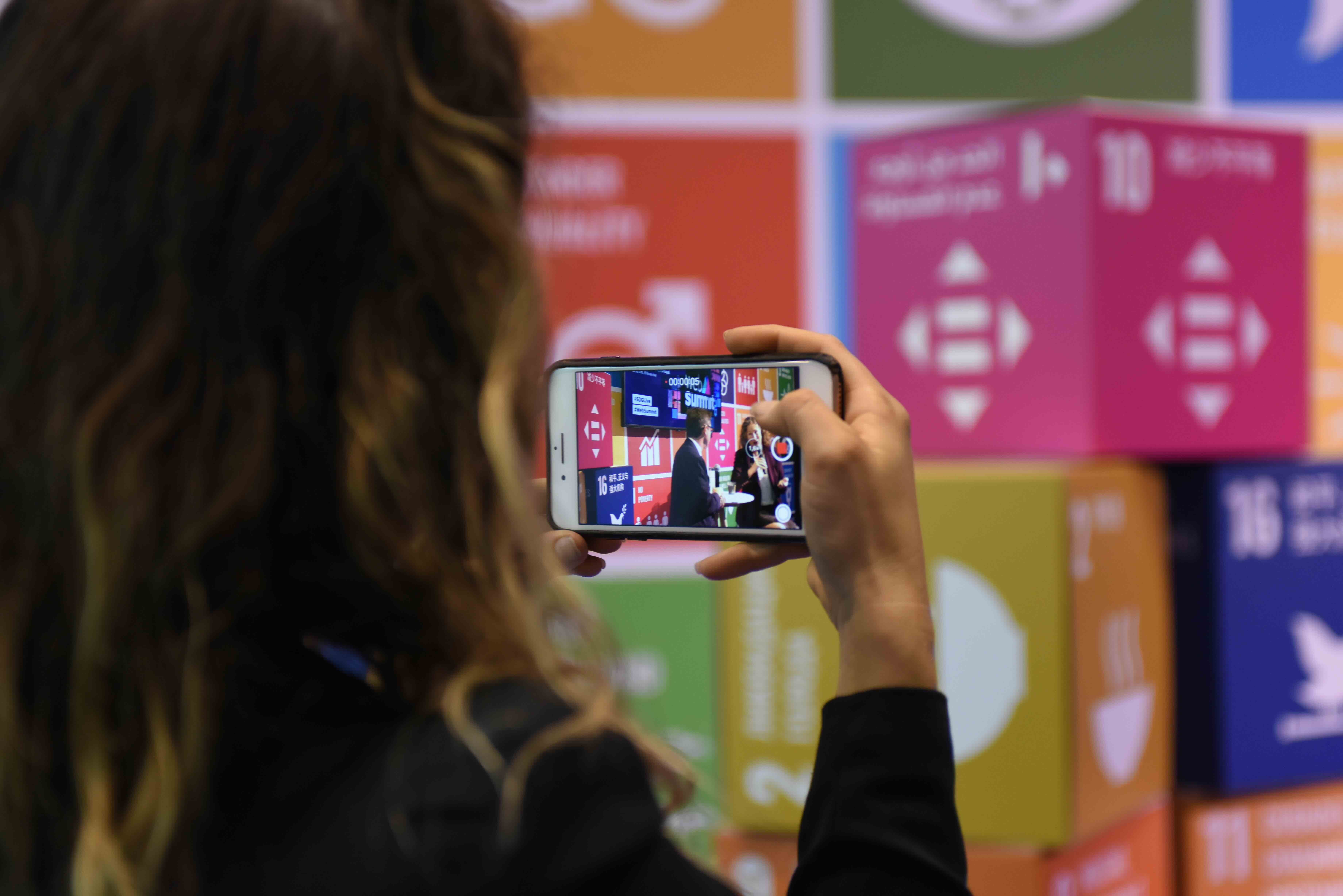 Participant taking a photo at the SDG Media Zone. UN Global Compact/Luís de Barros