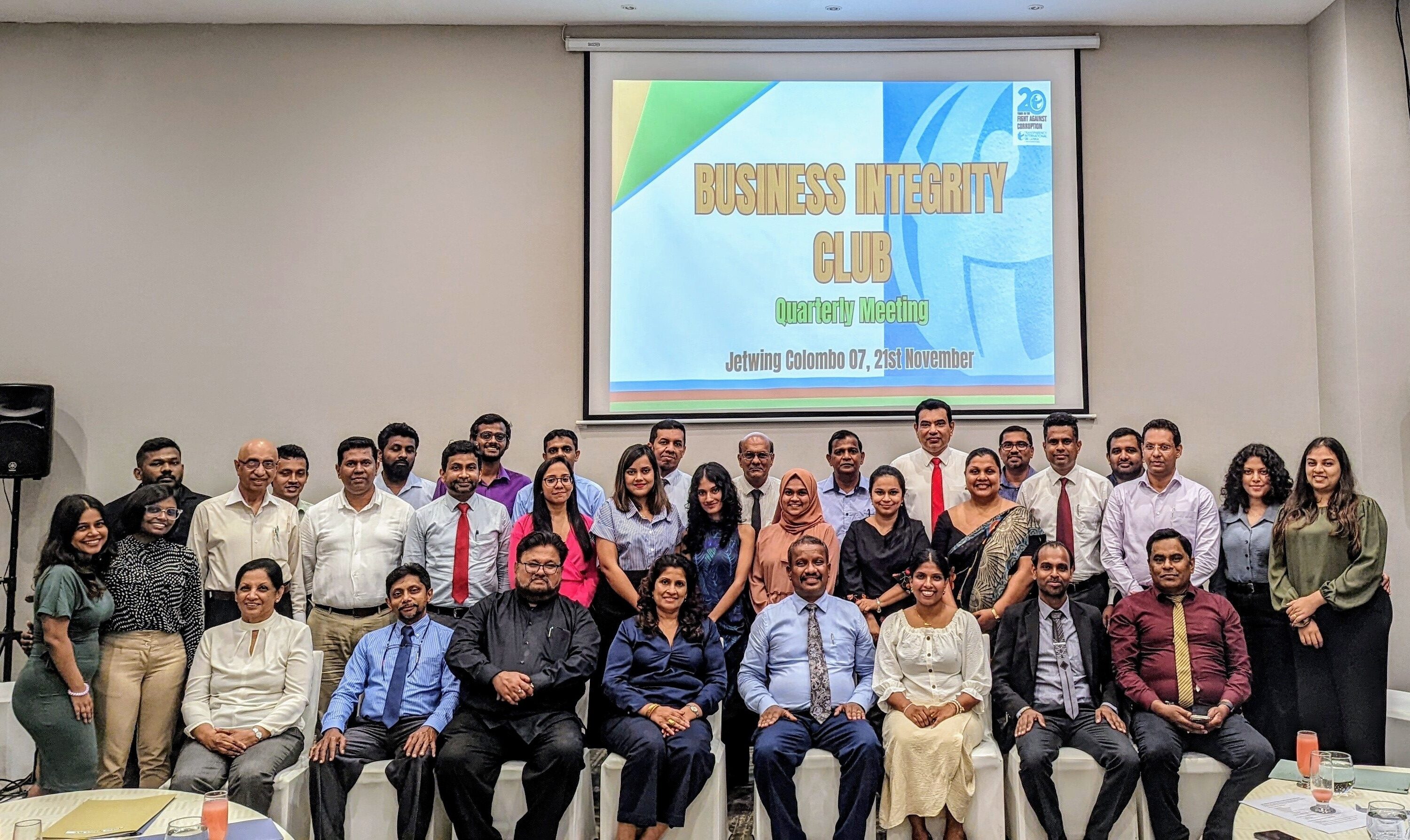 Group of people posing for a photo in a congress