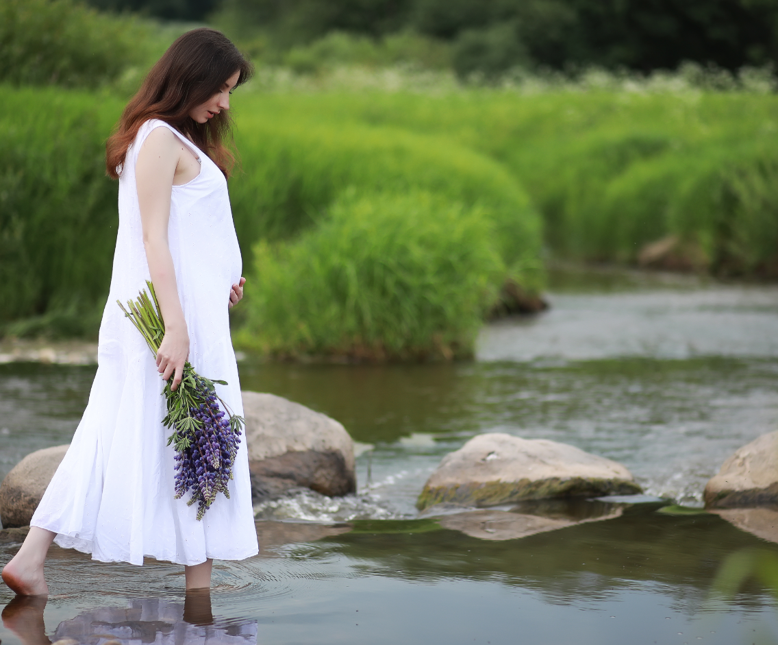 Woman walking into a river
