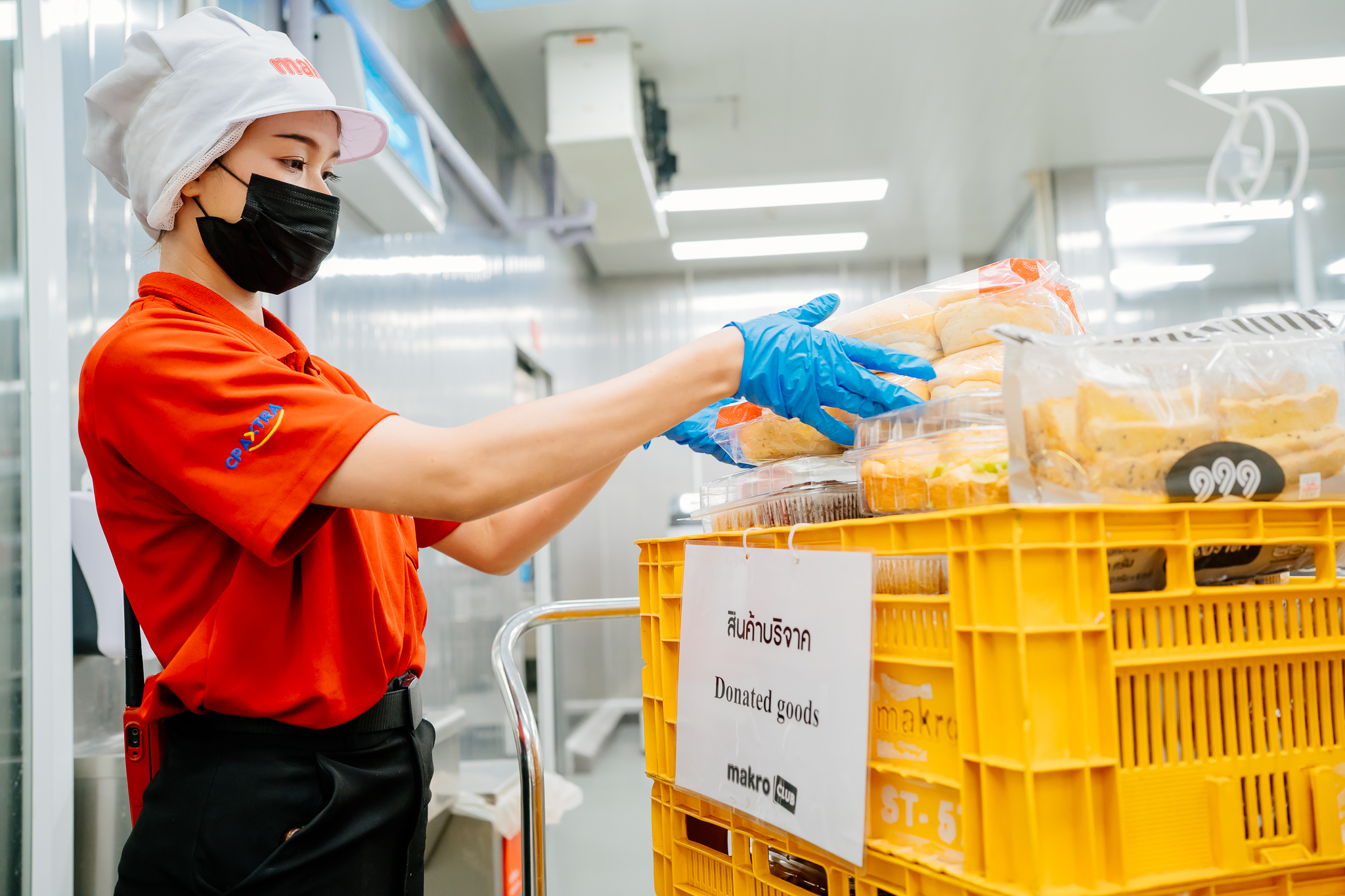 Worker packing a bag of vegetables