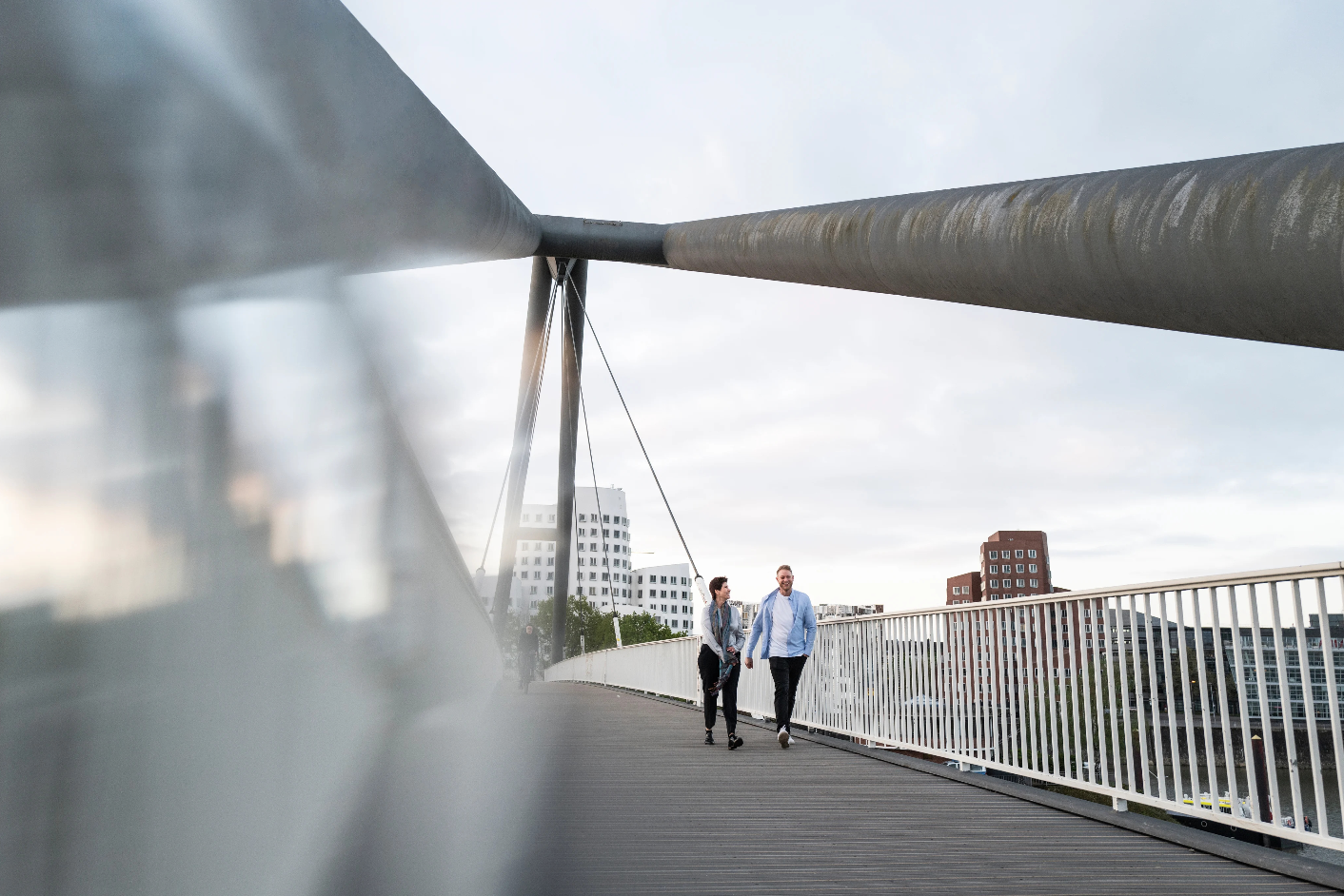 Couple walking across a steel bridge