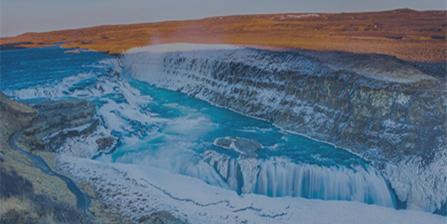 The image shows a mountain landscape with a water stream and waterfall in between.