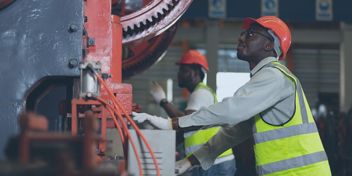 The image shows two male construction workers.