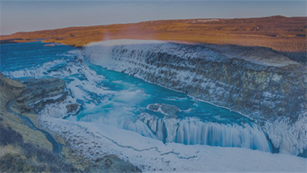 The image shows a mountain landscape with a water stream and waterfall in between.