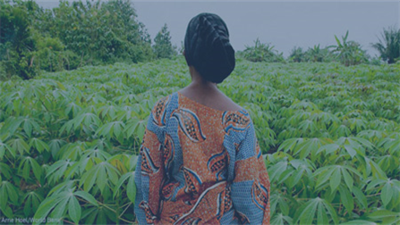 The image shows the profile of a woman facing a field of plants.