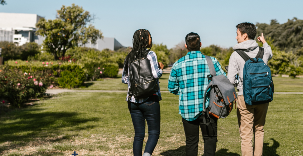 Three students walking outside in nature