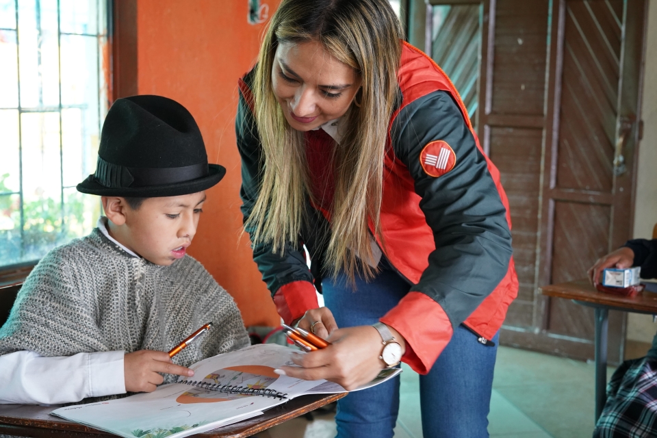 woman helping child with work