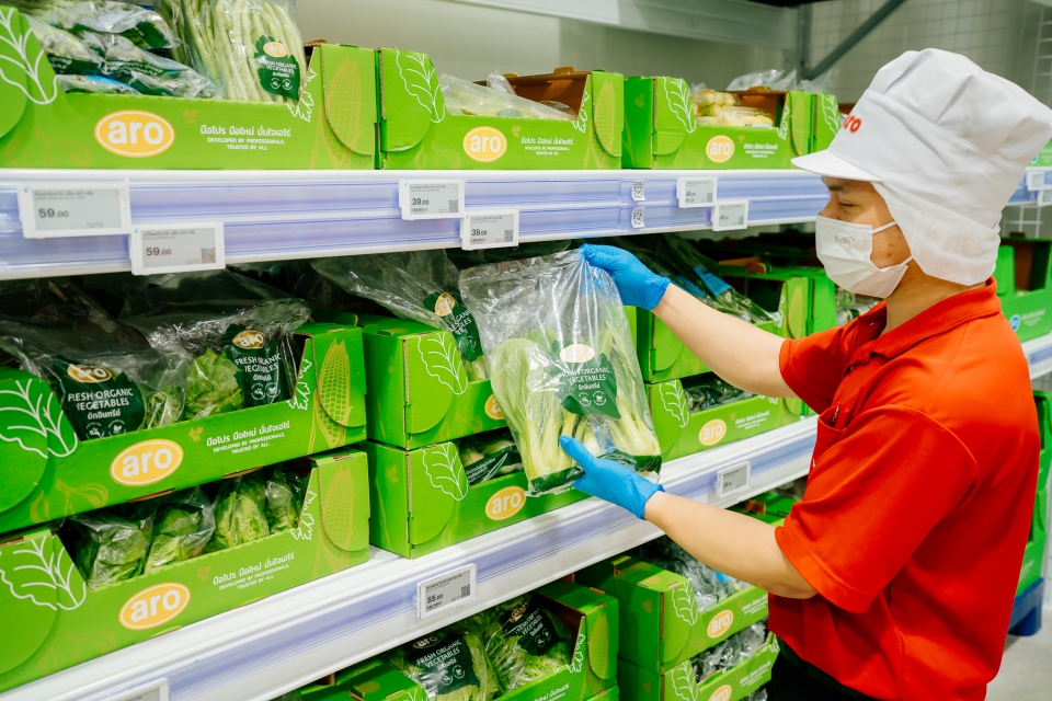 Worker packing a bag of vegetables