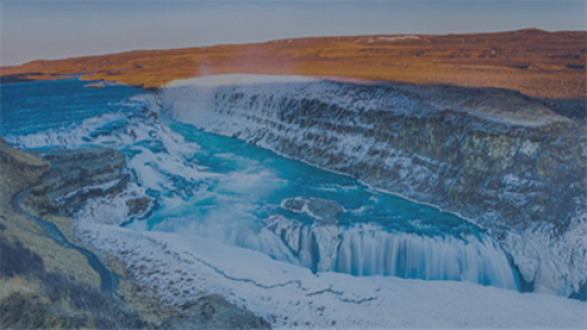 The image shows a mountain landscape with a water stream and waterfall in between.