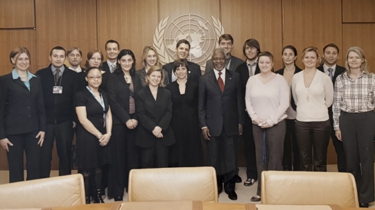 people standing behind the UN logo 