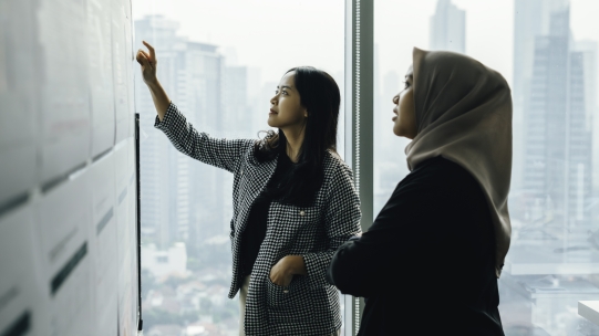 Women looking at a schedule