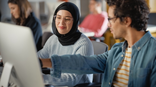 young professionals looking at computer screen 
