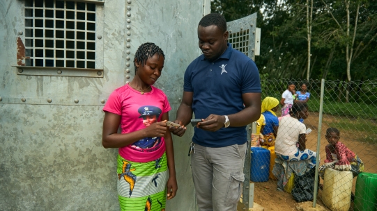 Woman and man talking in front of home