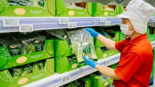 Worker packing a bag of vegetables